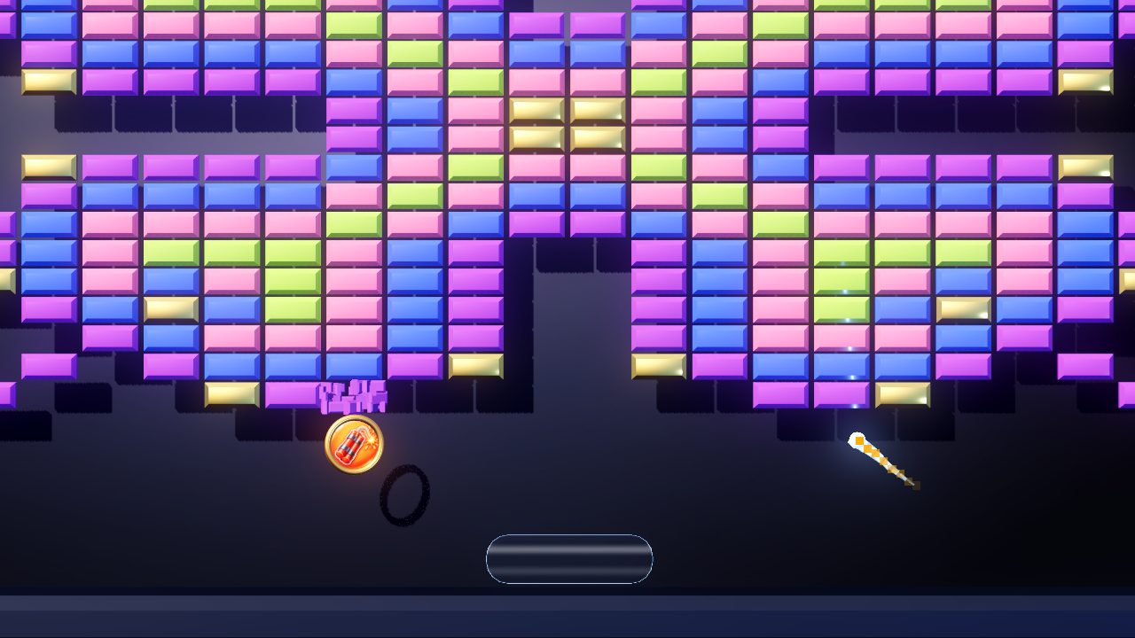 Modern, board 41 of MB21, detail crop: a Dynamite token with a gold 3D rim drops below a wall of pink, purple, blue, green and gold bricks, its ring-shaped shadow beneath it, with the ball climbing on the right and the paddle below.